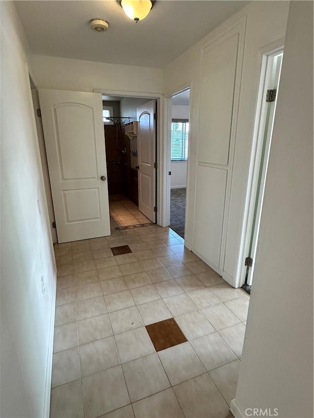 hallway featuring light tile patterned floors