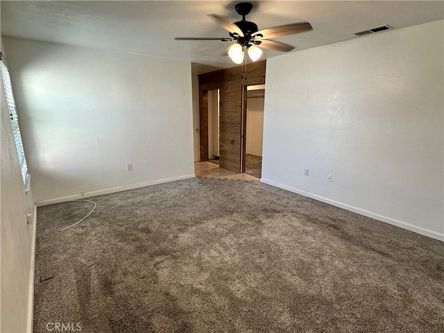 spare room featuring ceiling fan and carpet floors