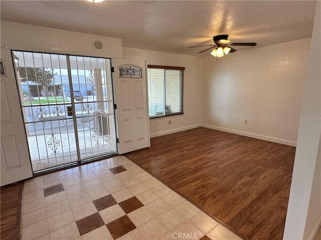 foyer with hardwood / wood-style floors, a textured ceiling, and ceiling fan