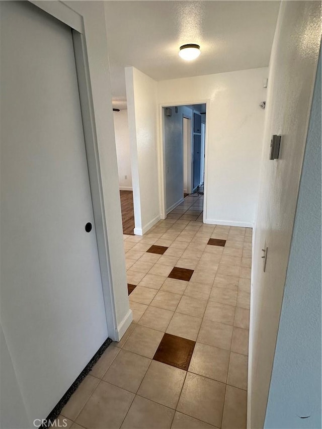 hall with light tile patterned flooring