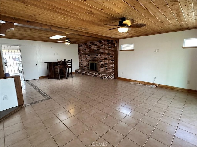 unfurnished living room with light tile patterned floors, wood ceiling, a fireplace, and ceiling fan