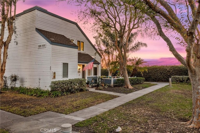 view of front of home with a shingled roof