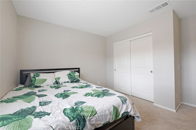 bedroom with light colored carpet and a closet