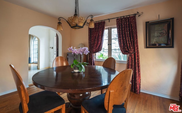 dining space with dark hardwood / wood-style flooring