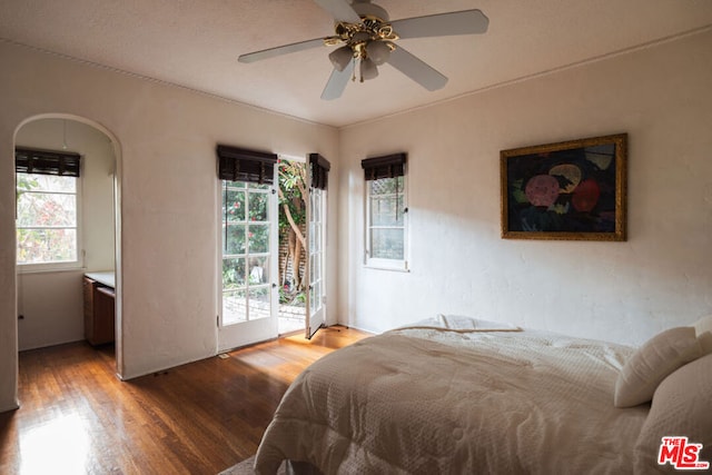 bedroom with access to exterior, hardwood / wood-style flooring, and ceiling fan