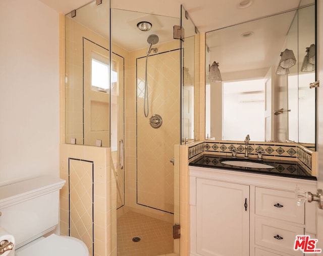 bathroom with an enclosed shower, vanity, and backsplash