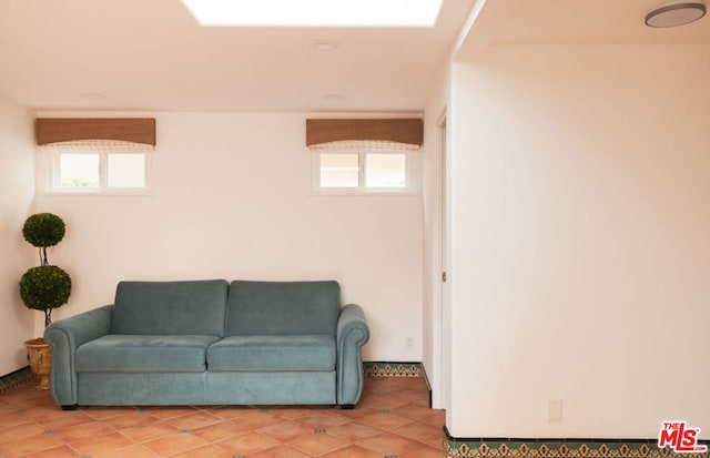 tiled living room featuring a healthy amount of sunlight