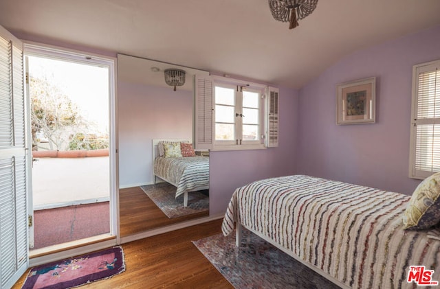 bedroom featuring lofted ceiling, access to outside, and hardwood / wood-style floors