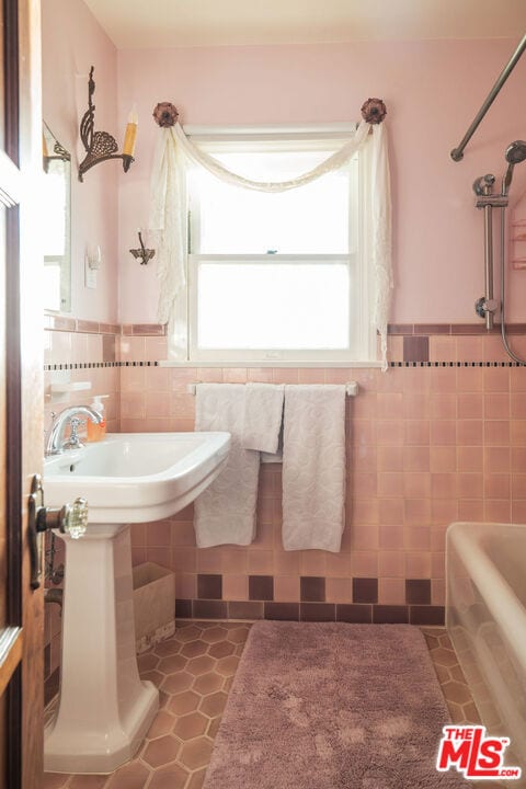 bathroom featuring tile patterned flooring and tile walls