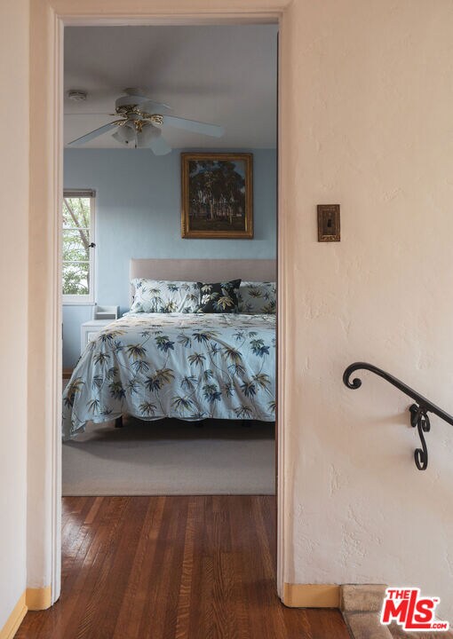 bedroom featuring ceiling fan and dark hardwood / wood-style flooring