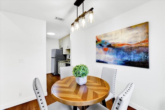 dining room with dark hardwood / wood-style flooring