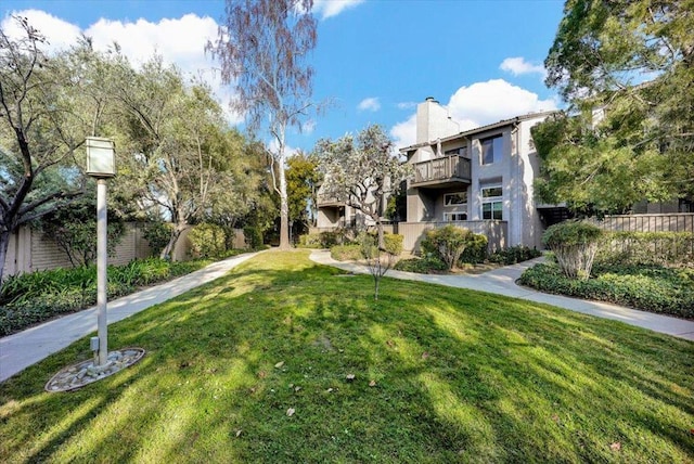 view of home's community featuring a lawn