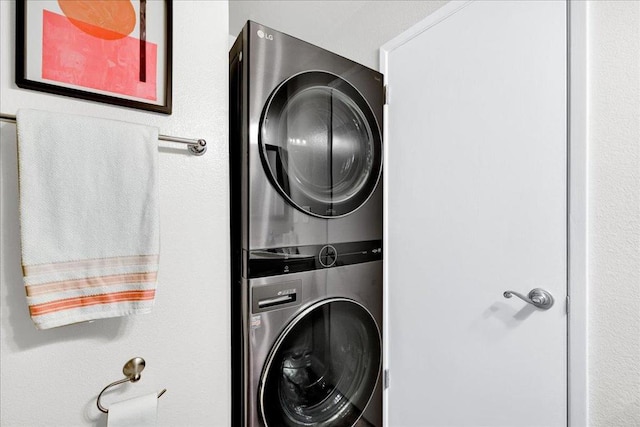 laundry area featuring stacked washer / dryer