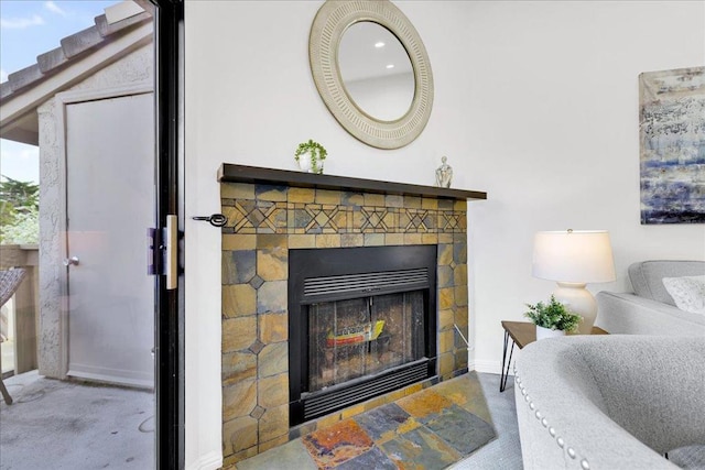 interior details featuring carpet floors and a tile fireplace