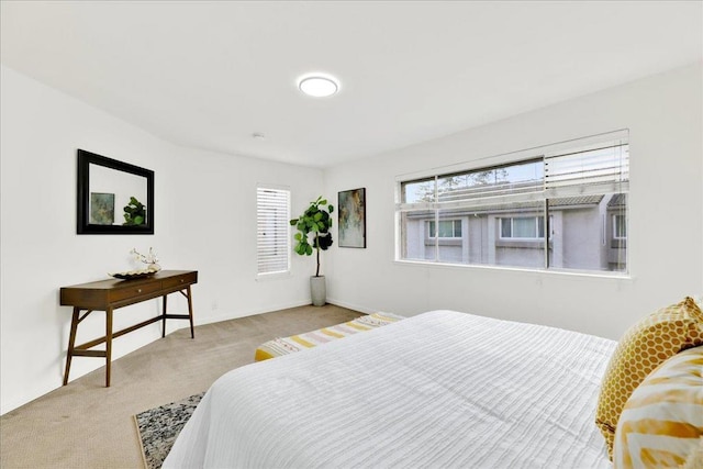 bedroom featuring light colored carpet