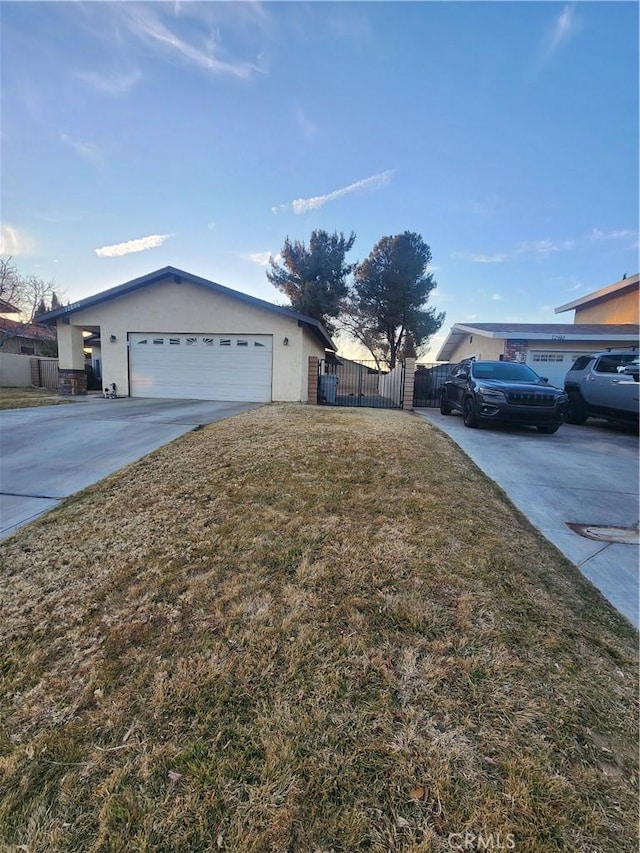 ranch-style house featuring a garage and a front lawn