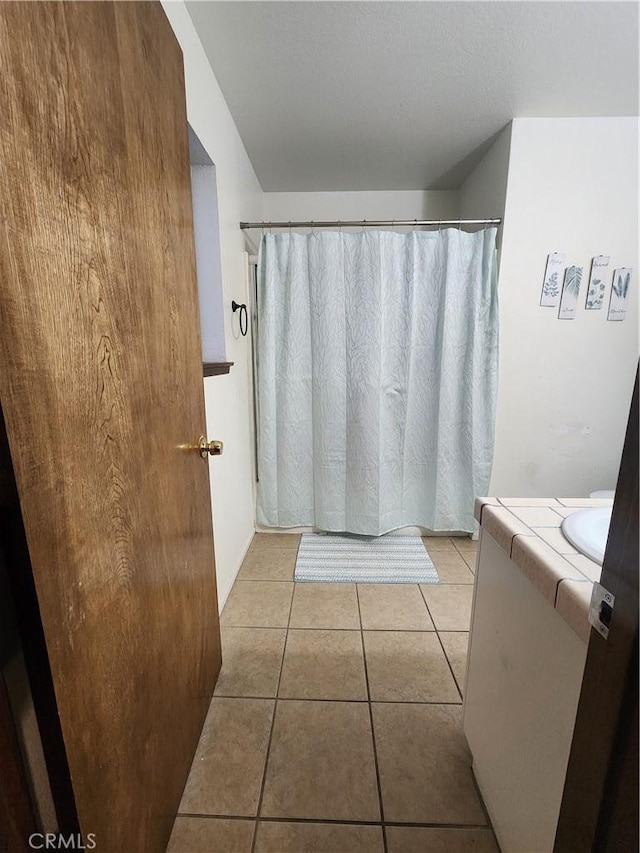 bathroom with tile patterned flooring and vanity