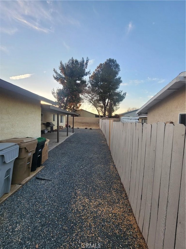 yard at dusk with a patio area