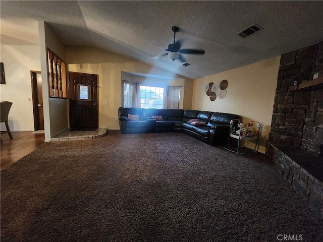 living room featuring lofted ceiling, carpet floors, and a textured ceiling