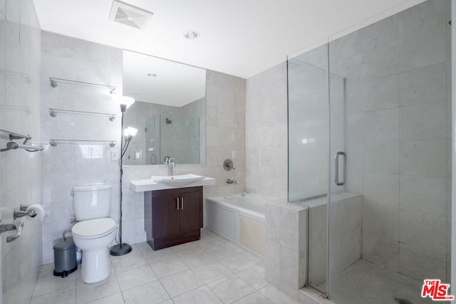 full bathroom with tile patterned floors, toilet, shower with separate bathtub, tile walls, and vanity