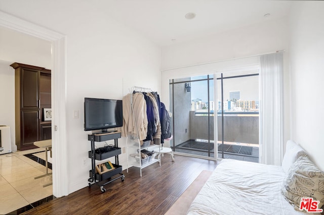 bedroom featuring dark wood-type flooring and access to outside