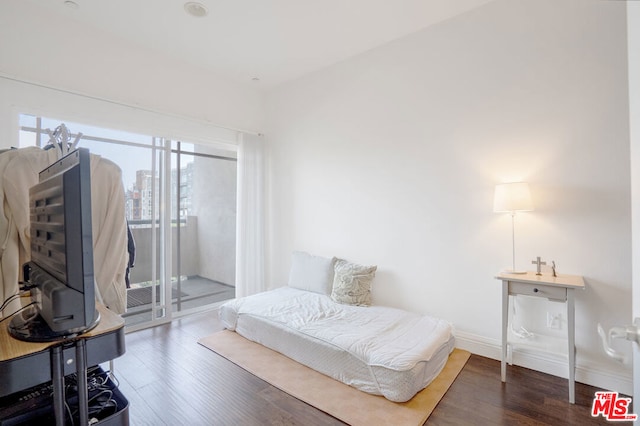 bedroom featuring dark hardwood / wood-style floors and access to outside