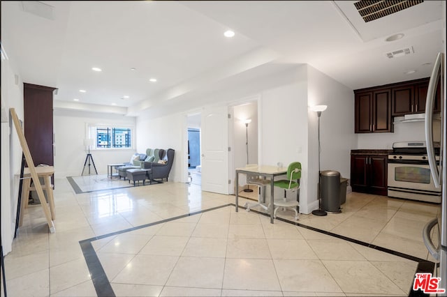 kitchen featuring light tile patterned floors and stainless steel range with gas stovetop