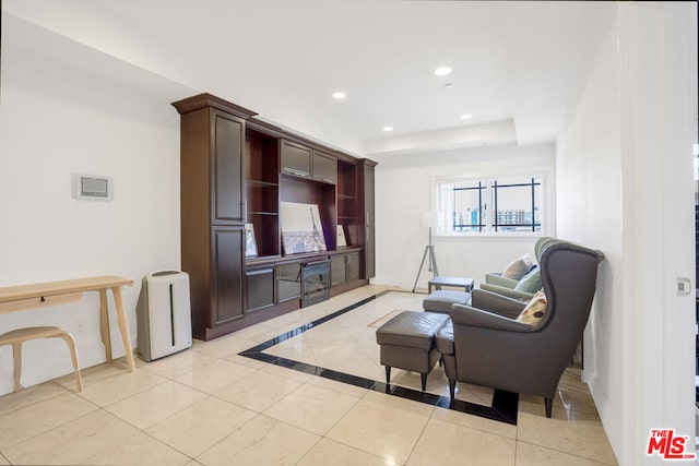 tiled living room with a tray ceiling