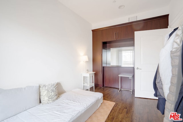 bedroom featuring dark hardwood / wood-style flooring