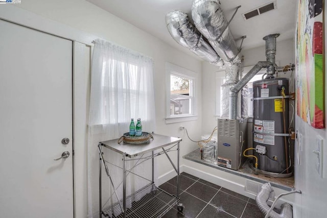 utility room featuring water heater