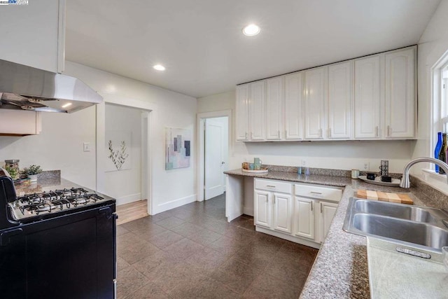 kitchen with black gas range, sink, and white cabinets