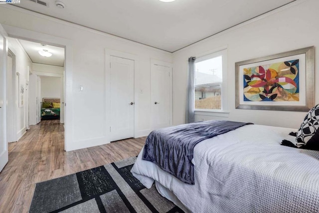 bedroom with hardwood / wood-style flooring and a closet