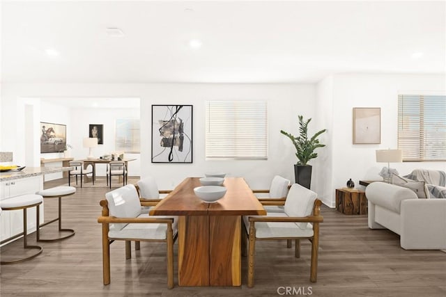 dining space with hardwood / wood-style floors