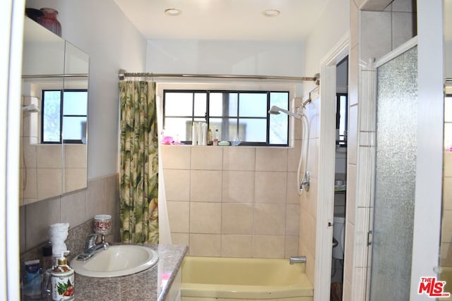 bathroom with vanity, a wealth of natural light, and shower / bath combination with curtain