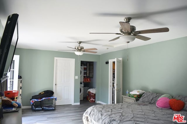 bedroom featuring ceiling fan, washer / dryer, and light hardwood / wood-style flooring