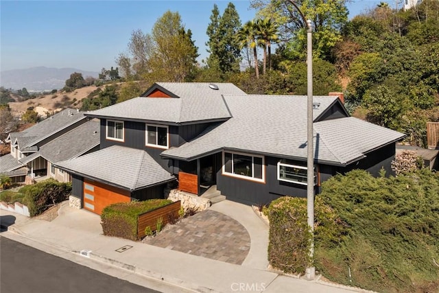 view of front of home with a garage and a mountain view