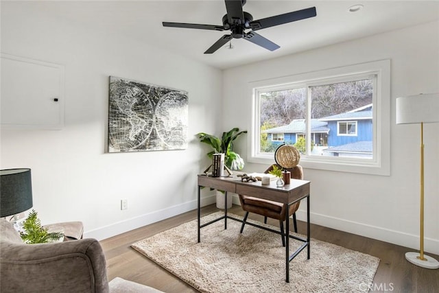 home office featuring wood-type flooring and ceiling fan