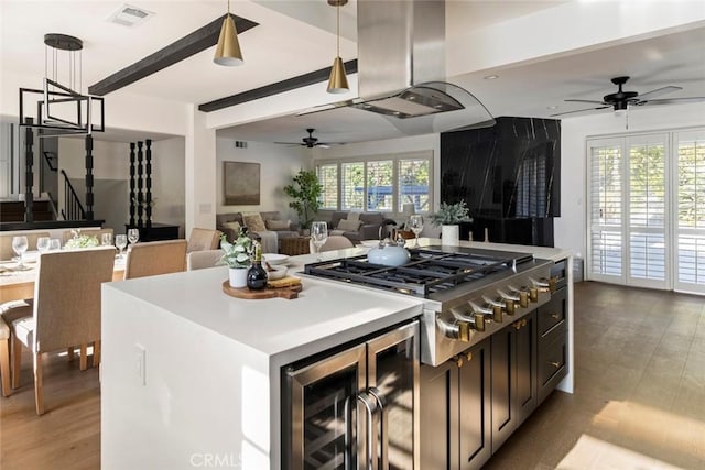 kitchen featuring pendant lighting, light hardwood / wood-style floors, stainless steel gas stovetop, and a kitchen island