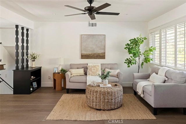 living room with dark hardwood / wood-style flooring and ceiling fan