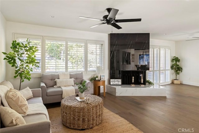 living room with dark hardwood / wood-style floors and ceiling fan