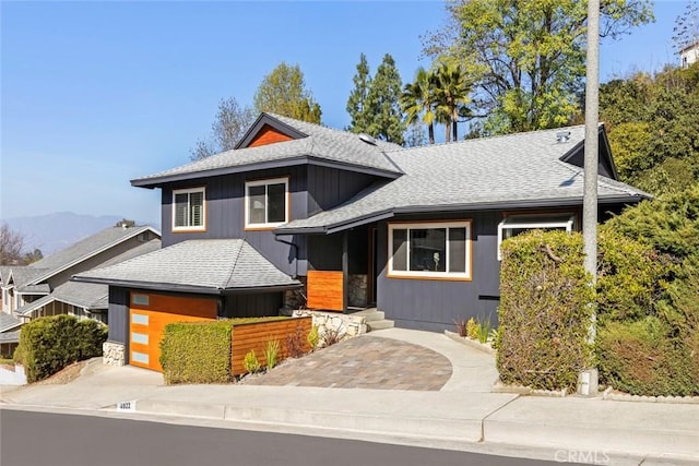 view of front facade with a garage and a mountain view