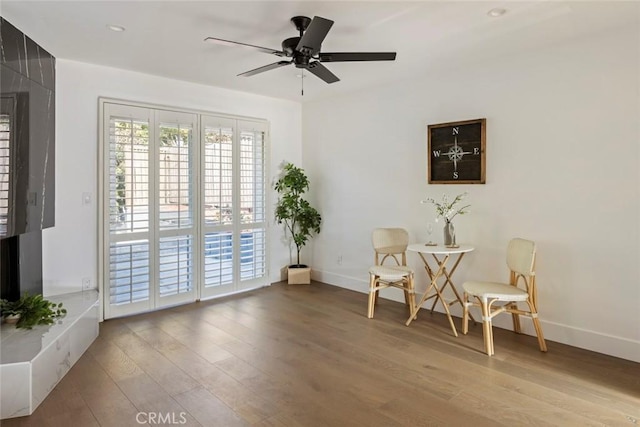 living area featuring ceiling fan and light wood-type flooring