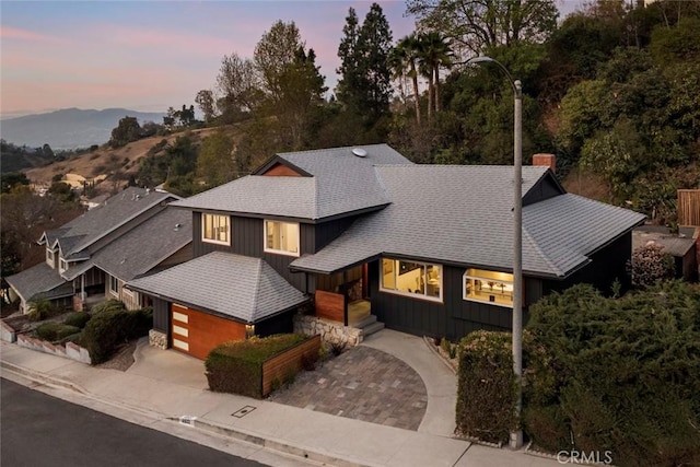 view of front of home with a garage and a mountain view