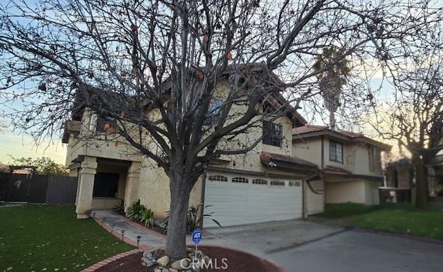 view of front facade with a garage and a yard