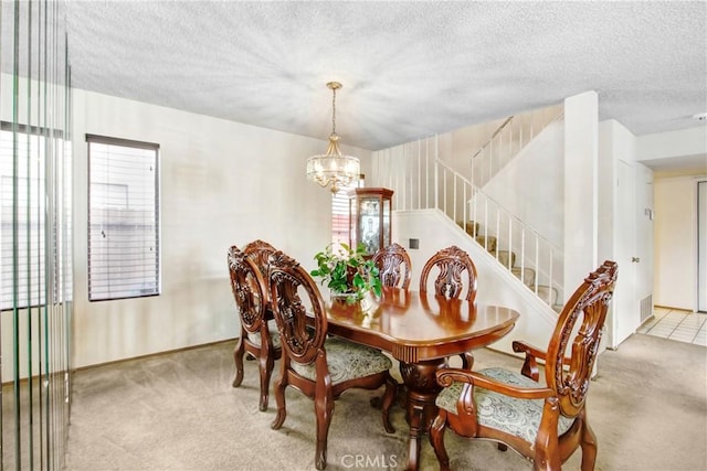 dining room featuring an inviting chandelier, plenty of natural light, and light colored carpet