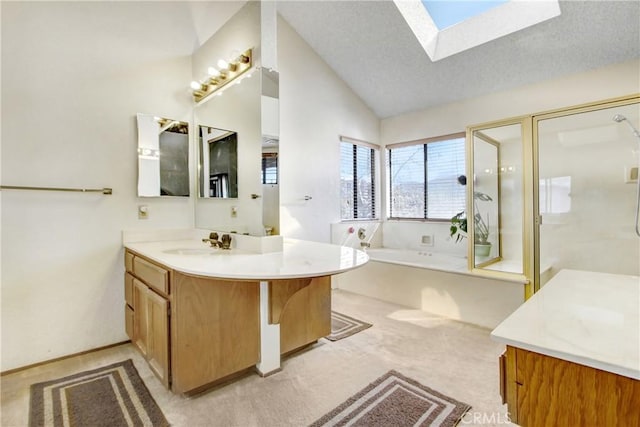 bathroom featuring vanity, lofted ceiling with skylight, independent shower and bath, and a textured ceiling