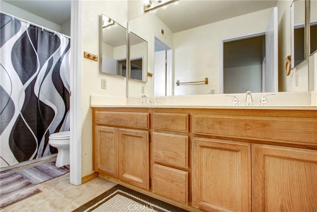 bathroom with vanity, a shower with shower curtain, tile patterned floors, and toilet