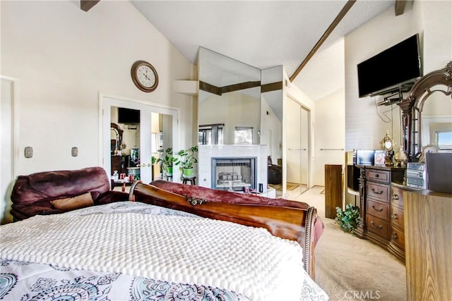 bedroom featuring high vaulted ceiling and light colored carpet