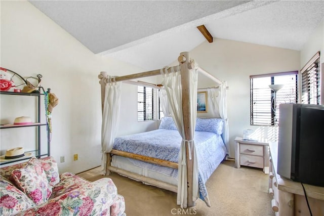 bedroom with lofted ceiling with beams, light carpet, and a textured ceiling