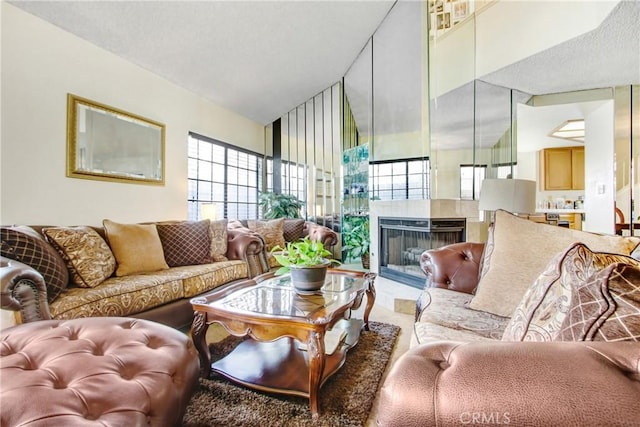 living room with a multi sided fireplace and a textured ceiling